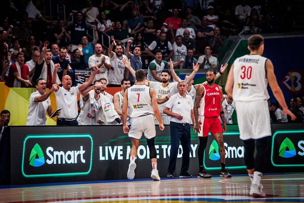 Serbia players and coaches celebrate during their win over Canada at the 2023 FIBA Basketball World Cup.